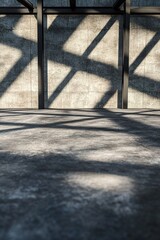In a striking architectural setting, overlapping black steel beams create linear patterns of shadows across a smooth concrete surface, offering a sleek and dramatic aesthetic