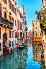 Venice, Italy. View of a narrow canal and boats moored near old houses