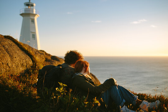 Couple enjoying sunset near Cape Spear Lighthouse, Canada