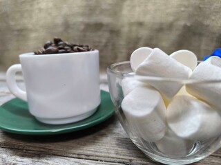 red and white cups filled with coffee beans and marshmallows