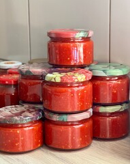 homemade vegetable preparations. jars of homemade adjika sauce. High quality photo
