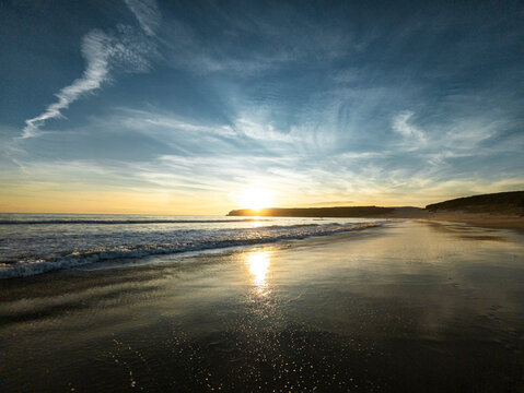Rippling ocean reflecting sunlight during a vibrant sunset