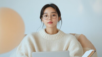 Chic Tech Workspace Young Asian Woman in Cozy Sweater with Glasses Editing on Laptop - Essential Linguistic Excellence and Professional Remote Editing Solutions