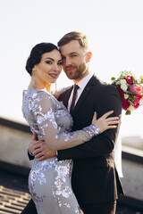Young couple on their wedding anniversary having photoshoot on the roof of the theatre