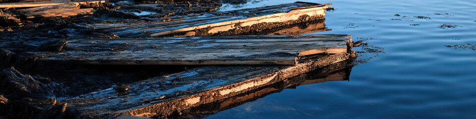Submerged Decomposed Wooden Planks in Water
