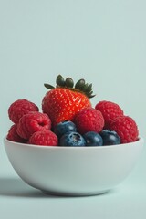 minimalistic scene of fresh berries in modern white bowl strawberries blueberries and raspberries in vibrant focus