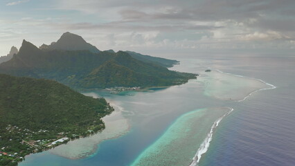 Aerial view Moorea island dramatic volcanic landscape, turquoise crystal clear lagoon, coral reef barrier, beautiful clouds during sunrise in French Polynesia. Wild travel destination, remote nature © Goinyk