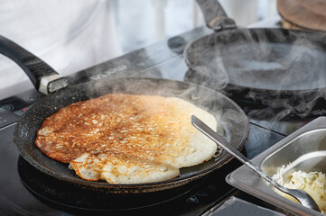 Pancakes are baked. Maslenitsa is a traditional Slavic holiday, pancakes are baked on the street. Pancake week