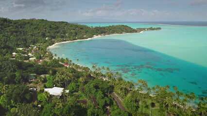 Breathtaking aerial views of Bora Bora island coast bay, crystal clear turquoise waters, tropical shore and luxury resort. Popular travel destination, remote wild paradise, exotic summer travel scene © Goinyk