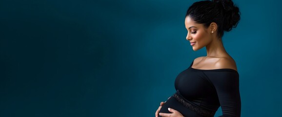 Pregnant woman in black dress on blue background, horizontal, perfect for maternity services, pregnancy wellness programs and prenatal care promotions