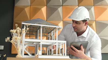 Professional caucasian architect engineer using tablet analysis house construction and checking...