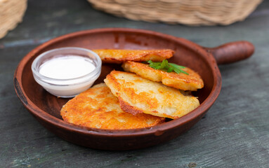 Potato pancakes with sour cream closeup. Belorussian cuisine