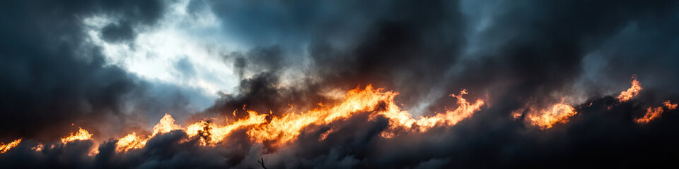 Wildfire Flames Beneath Storm Clouds
