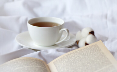 mug of hot tea and book