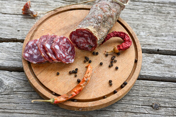 Air-dried typical  Italian salami from Tuscany served on a wooden board .  Autentic Tuscan Salami from San Gimignano, Siena 