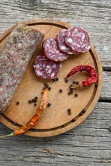 Air-dried typical  Italian salami from Tuscany served on a wooden board .  Autentic Tuscan Salami from San Gimignano, Siena 