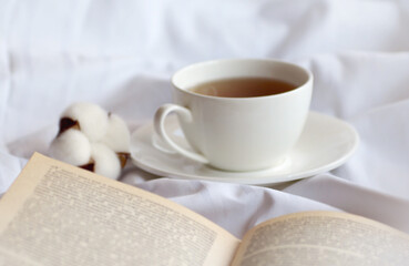 mug of hot tea and book