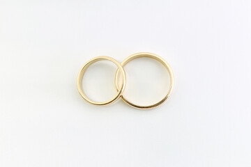 Two gold wedding rings. Marriage. White background.