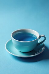 blue tea in a minimalist teacup on a subtle blue background, simple, ceramic, elegant