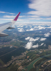 Fototapeta premium beautiful thick clouds in the sky from the height of the flight of the plane with a view of the wing with engines