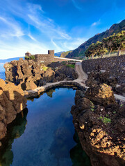 Fototapeta premium beautiful castle and swimming pool on rocky mountains by the sea on the island of Madeira in Portugal