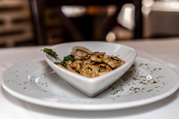 Sliced mushrooms with garlic and parsley resting in a heart-shaped bowl