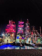 beautiful ships and boats are moored near the shore