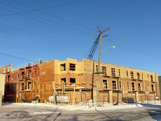 construction of a wooden building using a crane