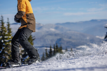 Close-up of snowboarder with flying snow, selective focus. Winter sports concept