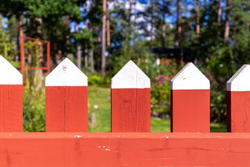 Red and white fence in a garden