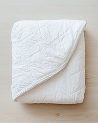 Obraz premium Neatly folded white quilt