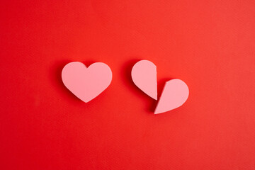 Broken and whole hearts on red background. Relationship problems concept. Emotions