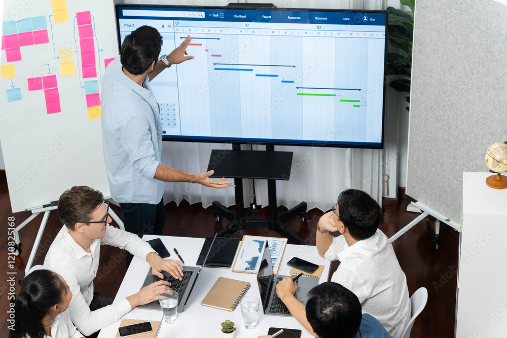 Leinwandbilder Project manager communicate and collaborate with team using project management software display on monitor, tracking progress of project task and making schedule plan at meeting table. Prudent