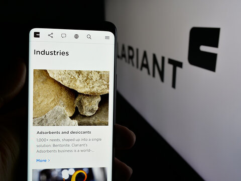 Stuttgart, Germany - 01-20-2025: Person holding mobile phone with web page of Swiss specialty chemicals company Clariant AG on screen with logo. Focus on center of phone display.