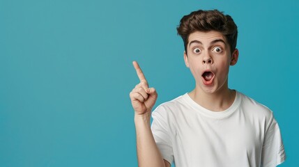 The surprised boy opened his mouth and pointed at the photocopying area while standing.