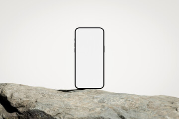 Phone with the blank white screen on the rock