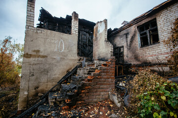 Consequences of fire. Burnt ruined house