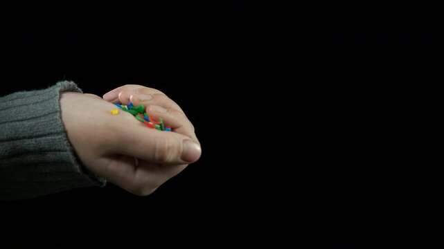 Child with microplastic on black. A view of child hands with microplastic against black background. A concept of Earth plastic pollution.