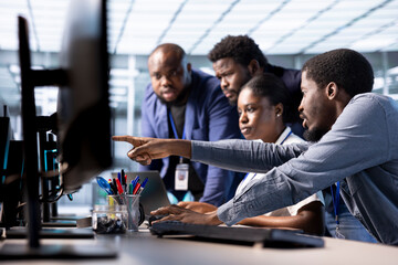 Data center coworkers doing brainstorming, creating technical documentation for software...