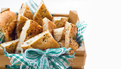 Sliced Traditional Turkish Ramadan Bread on wooden case at white surface with copy space