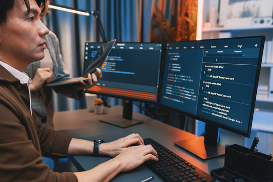 Serious of IT developers discussing intelligent website development coder system running data online two screens with laptop showing information network at neon light room at modern office. Infobahn.