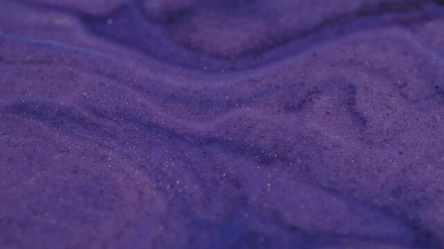 Violet leak. Purple flow. Fantasy wavy texture with floating ink glitter circles. Mixing of paint ripple color surface deformation.