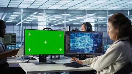 IT support workers in AI data center coding on green screen computers, upgrading equipment....