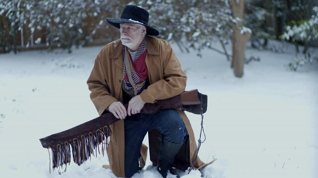 old west cowboy hunter in the snow