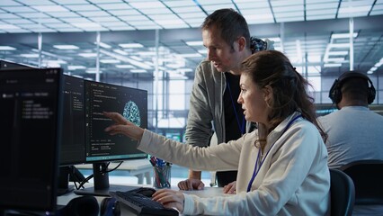 IT team members programming scripts on computer, employing AI machine learning. Software developer...