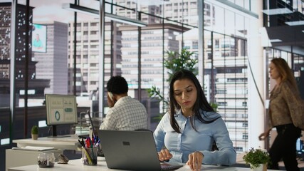 Executive assistant at multinational company work on next big business project. Indian worker uses...