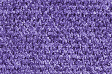 Texture of purple jacquard fabric, close up of rough weave macro. Material for home textile, upholstery and curtain decor, garment. Background, wallpaper, backdrop.