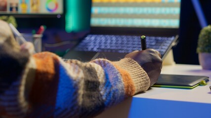 Male graphic artist using essential digital tools on dual monitors, professional design work...