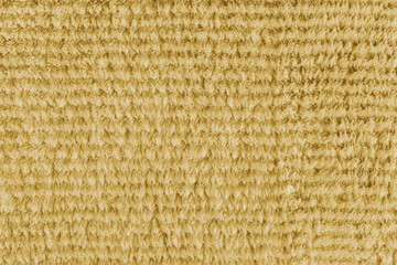 Terry cloth, striped pattern yellow towel texture background. Soft fluffy textile bath or microfiber beach towel material. Top view, close up, macro.