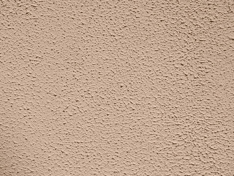 Pale beige pink paint wall texture or background with gotele, grainy, textured, scratched, rough and scratchy effect for typical Mediterranean house, chalet and villa exteriors in Spain.